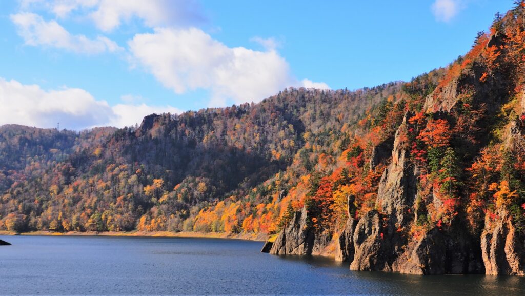 紅葉した山々に囲まれた豊平峡ダムの定山湖